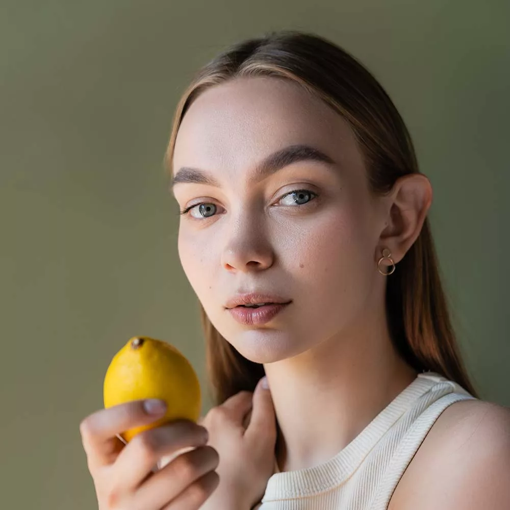 portrait of charming woman with ripe lemon looking px59vbb.jpg